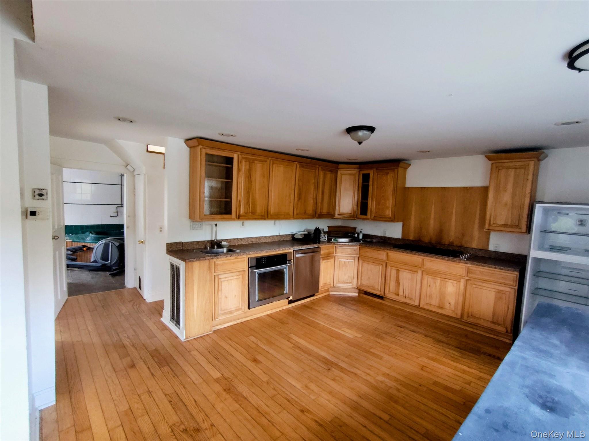 983 Plank Road Forestburgh, NY 12777 - Photo 15 of 50 Kitchen featuring wood-finish flooring, natural wood cabinetry, dark-toned countertops, and stainless-steel appliances