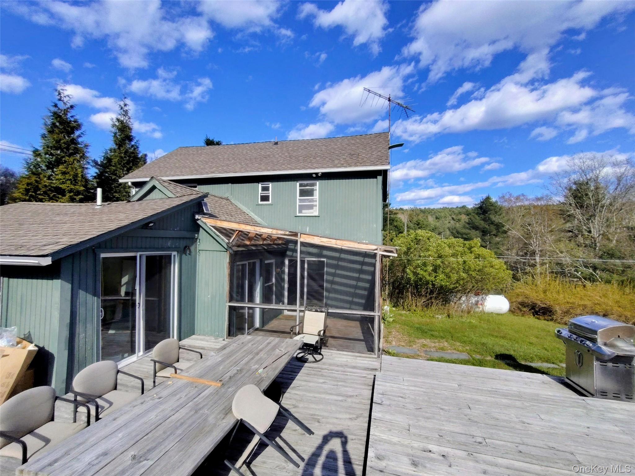983 Plank Road Forestburgh, NY 12777 - Photo 18 of 50 Multi-level exterior with green siding and brown shingle roofing