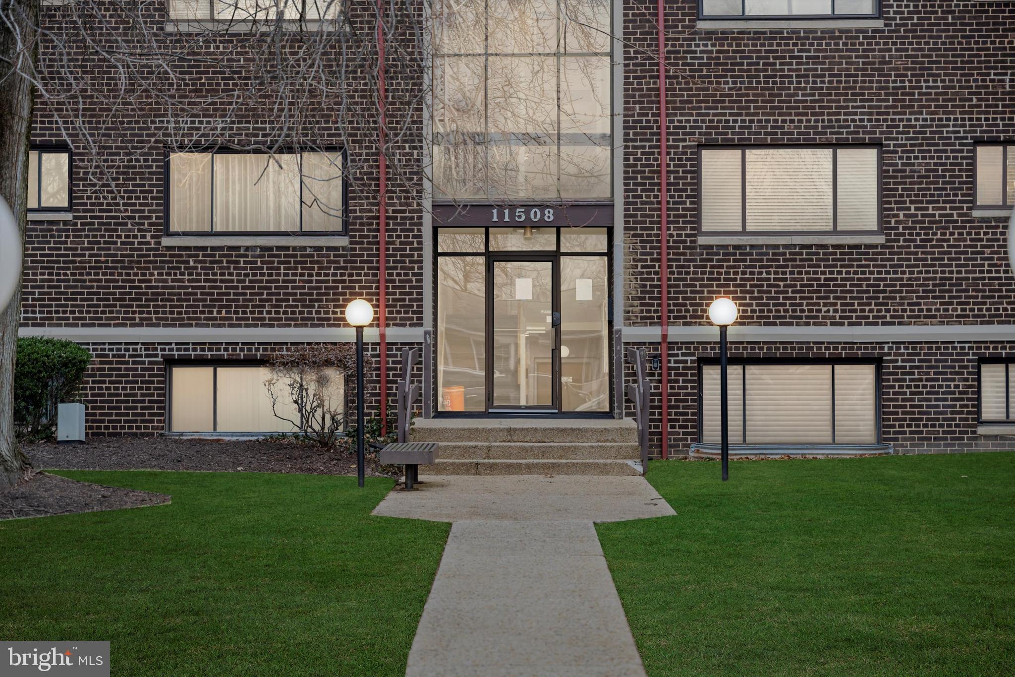 a front view of a house with a garden and yard