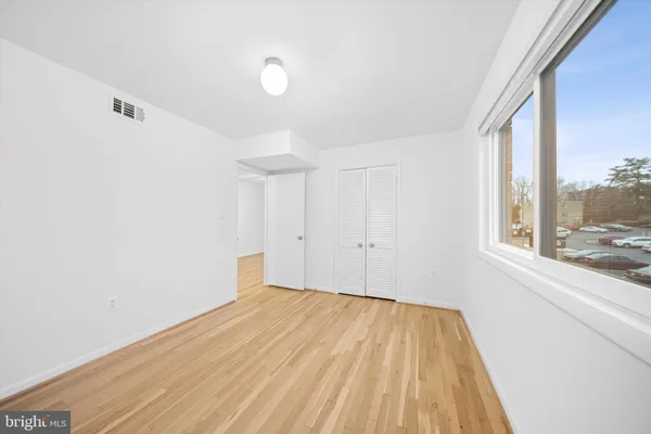 a view of a room with wooden floor and brick walls