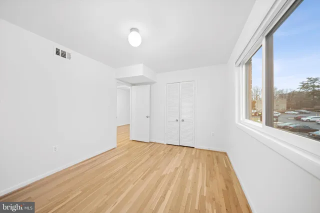 a view of a room with wooden floor and brick walls