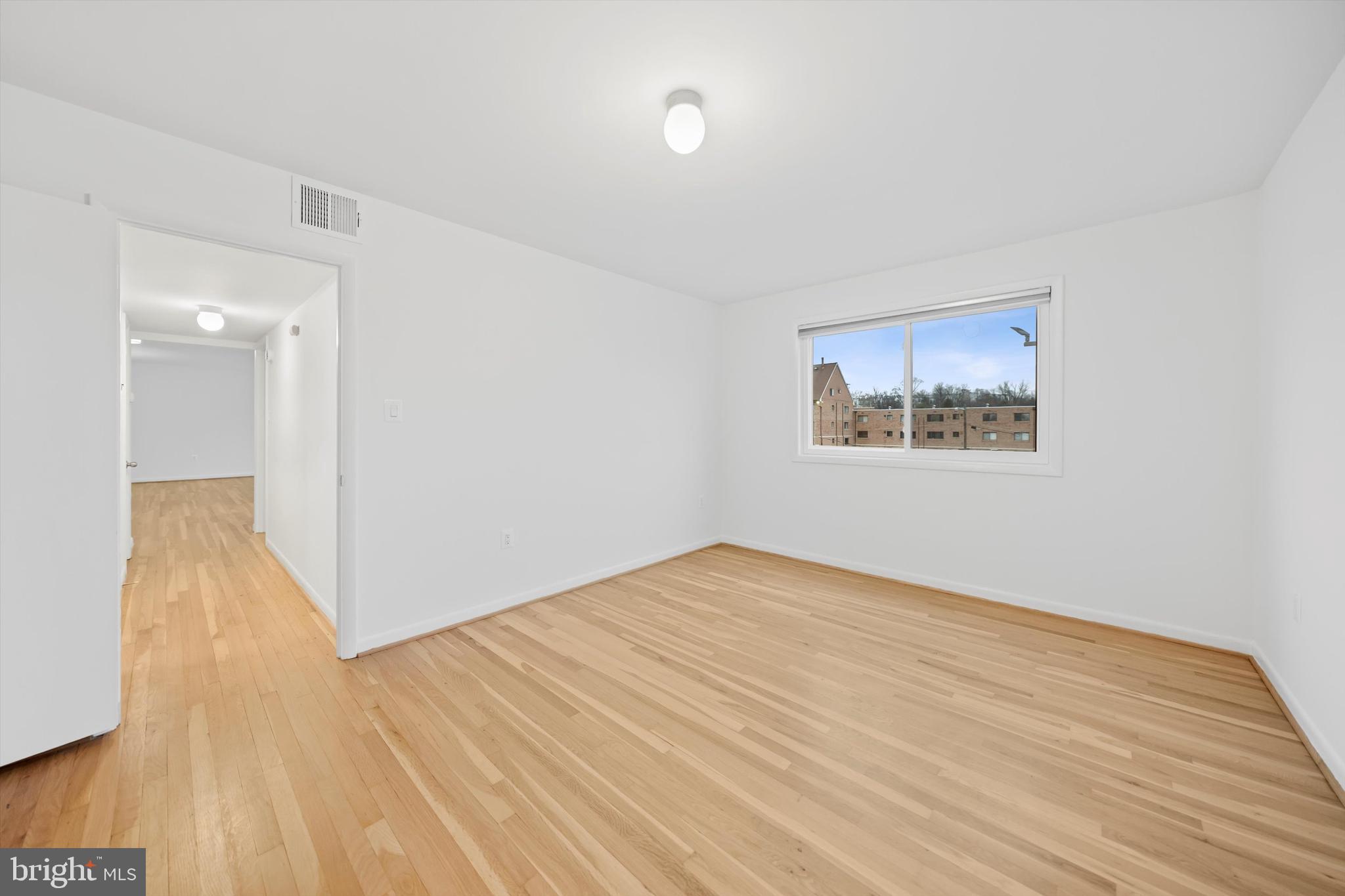 11508 Bucknell Drive, Unit 203 Silver Spring, MD 20902 - Photo 19 of 21 a view of an empty room with wooden floor