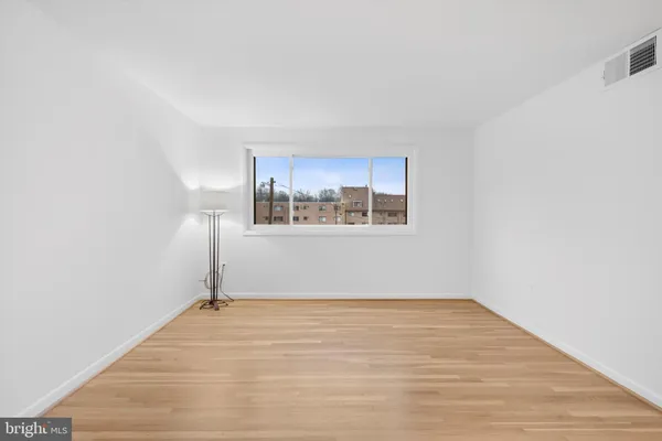 a view of a room with wooden floor and window
