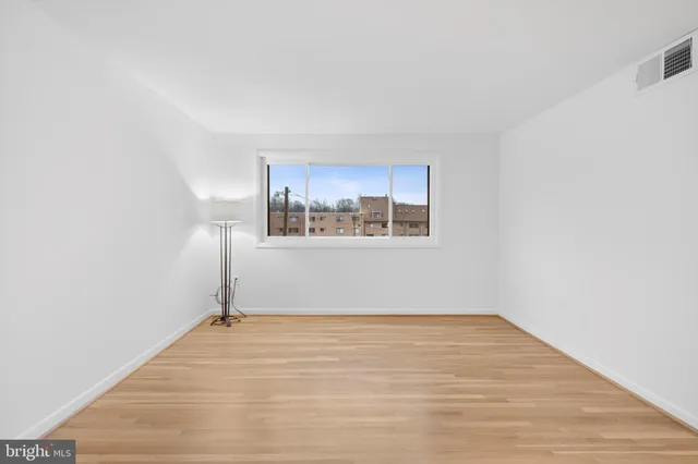 a view of a room with wooden floor and window