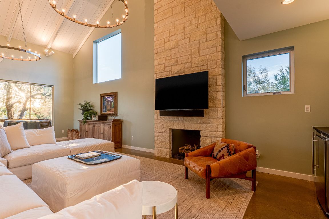23601 Old Ferry Road, Unit 20 Spicewood, TX 78669 - Photo 12 of 40 a living room with furniture a fireplace and a flat screen tv