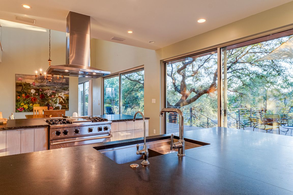 23601 Old Ferry Road, Unit 20 Spicewood, TX 78669 - Photo 14 of 40 Propane cooktop with stainless exhaust hood and large kitchen island