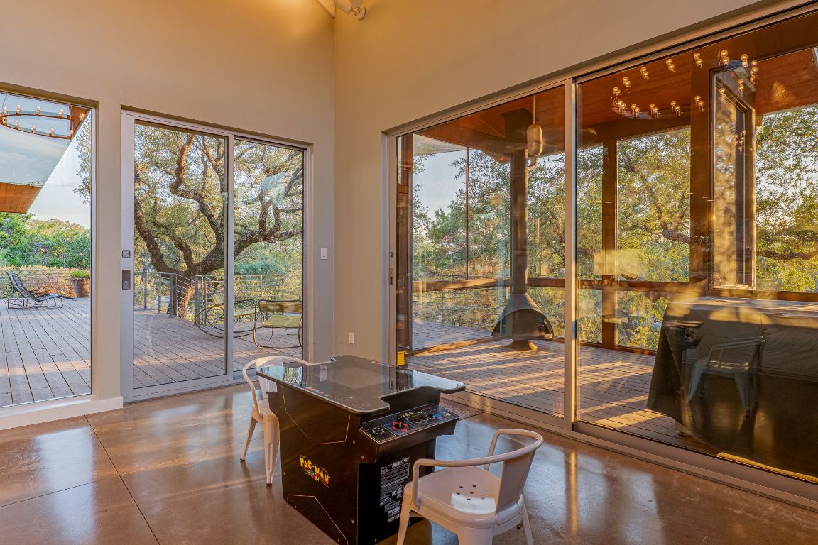 23601 Old Ferry Road, Unit 20 Spicewood, TX 78669 - Photo 16 of 40 a living room with large windows with wooden floor