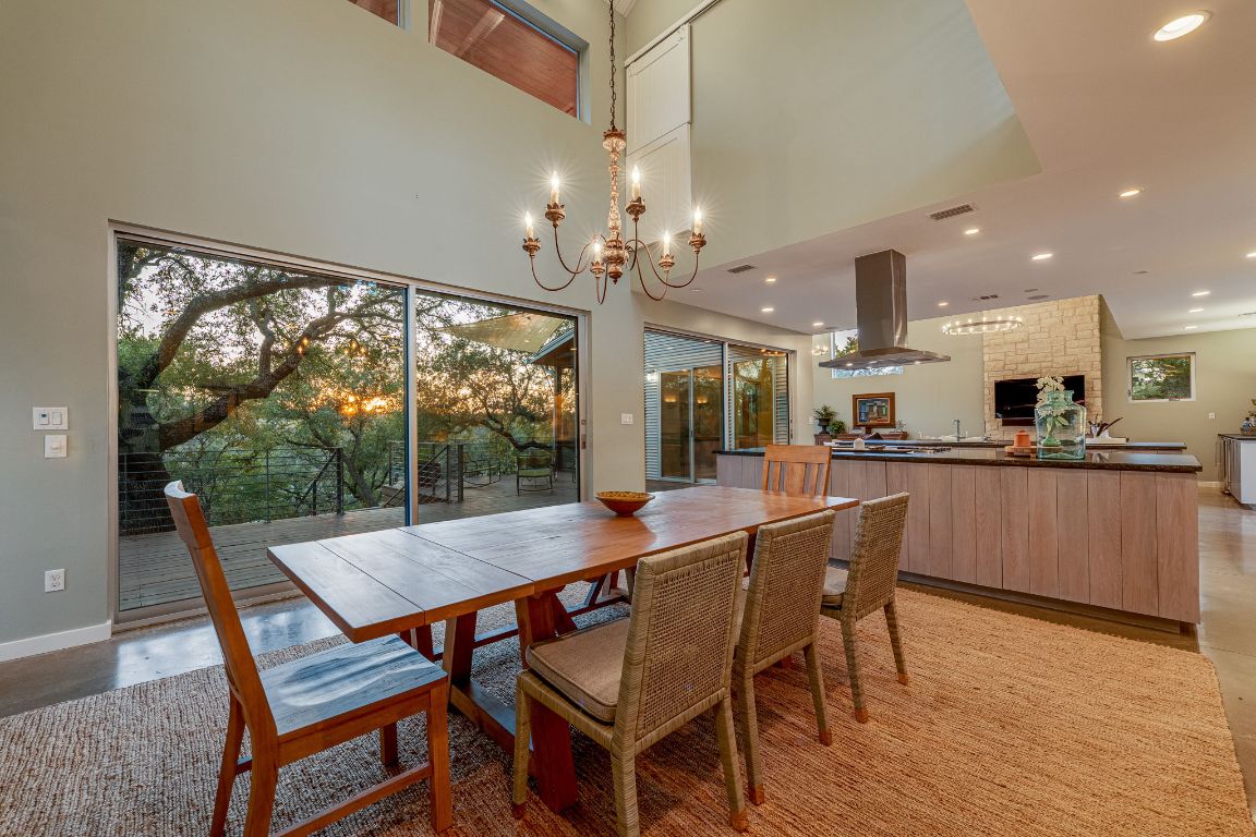 23601 Old Ferry Road, Unit 20 Spicewood, TX 78669 - Photo 18 of 40 a view of a dining room with furniture large windows and wooden floor