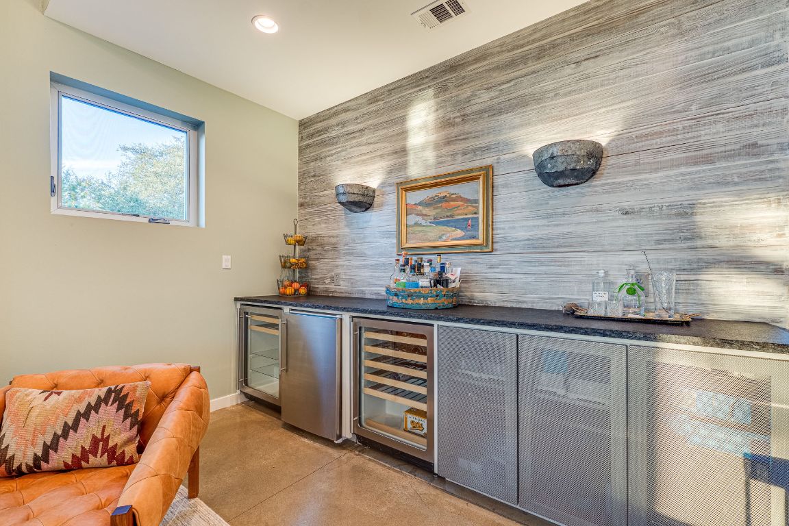 23601 Old Ferry Road, Unit 20 Spicewood, TX 78669 - Photo 19 of 40 a kitchen with stainless steel appliances granite countertop a sink and cabinets