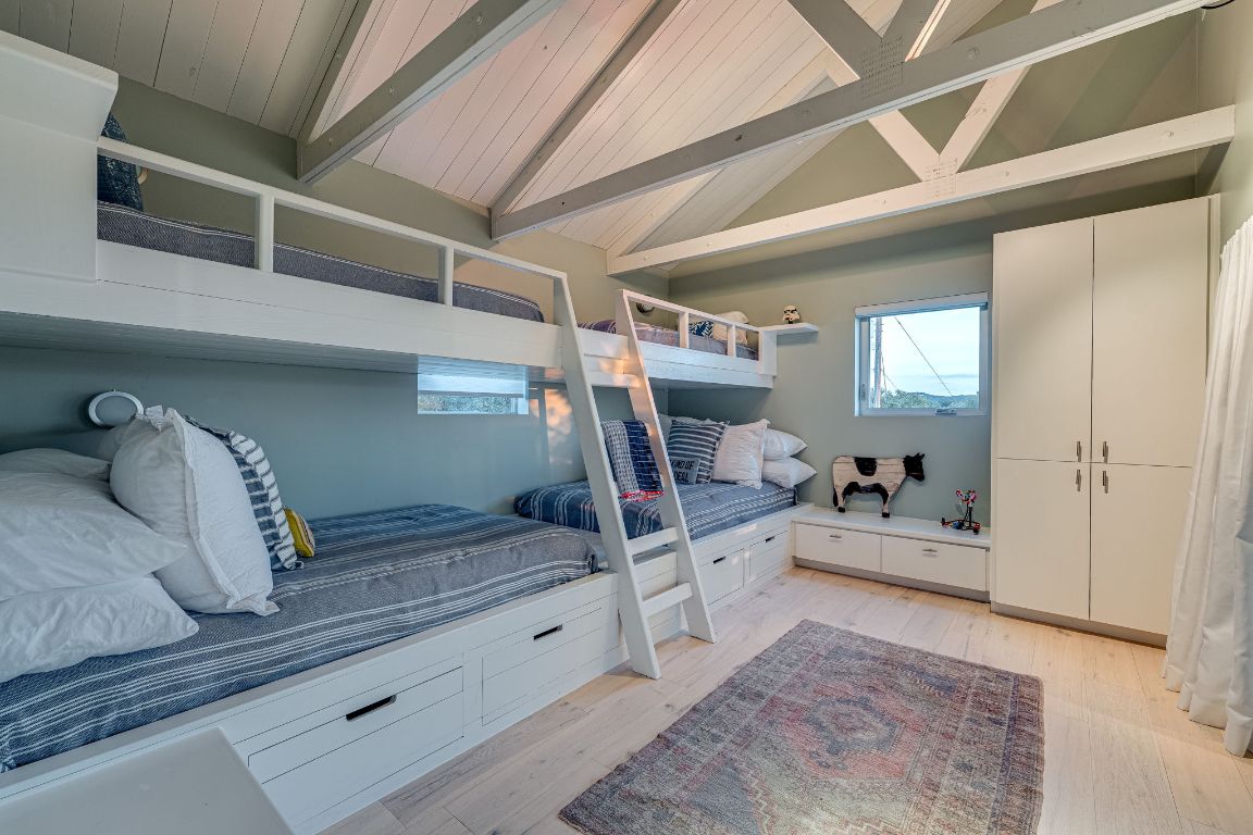 23601 Old Ferry Road, Unit 20 Spicewood, TX 78669 - Photo 26 of 40 Beamed ceiling adds to this casual bedroom