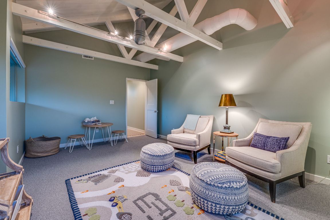 23601 Old Ferry Road, Unit 20 Spicewood, TX 78669 - Photo 28 of 40 a living room with furniture and a chandelier