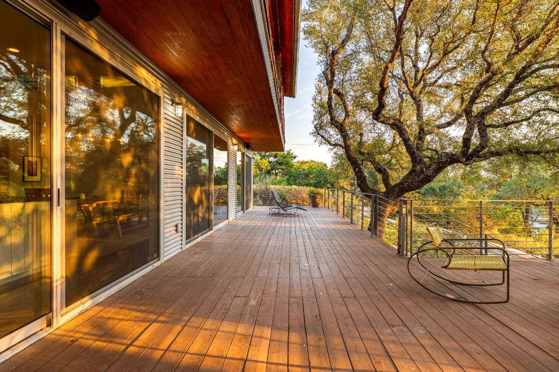 23601 Old Ferry Road, Unit 20 Spicewood, TX 78669 - Photo 31 of 40 a view of balcony with wooden floor and bench
