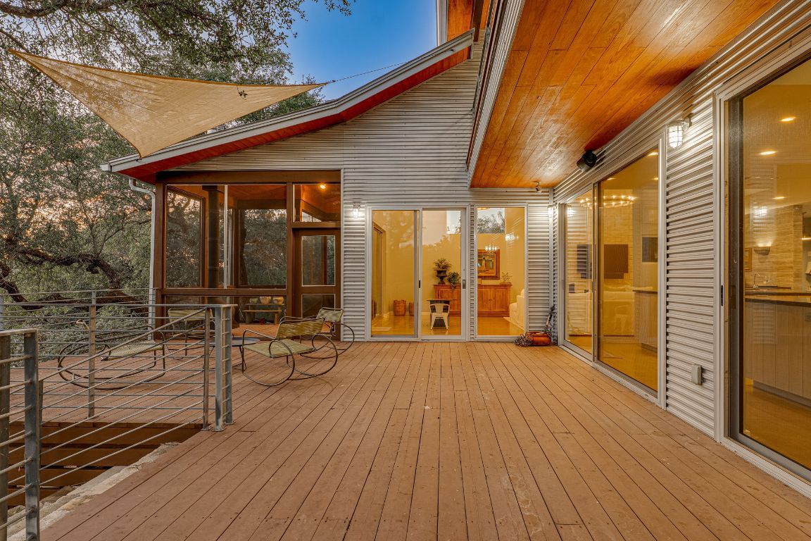 23601 Old Ferry Road, Unit 20 Spicewood, TX 78669 - Photo 32 of 40 a view of a patio with table and chairs with wooden floor and fence