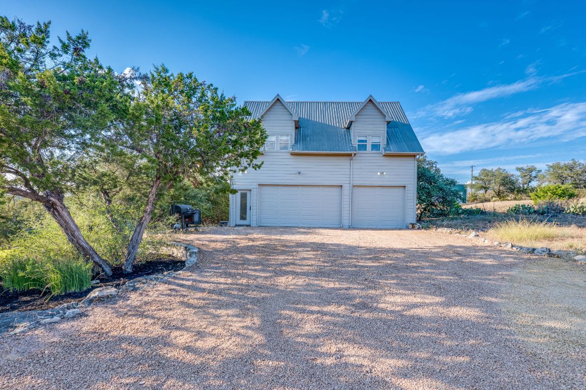 23601 Old Ferry Road, Unit 20 Spicewood, TX 78669 - Photo 36 of 40 a house view with a garden space