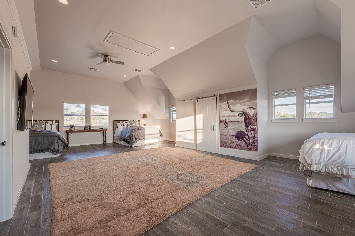 23601 Old Ferry Road, Unit 20 Spicewood, TX 78669 - Photo 37 of 40 a spacious bedroom with a bed and a large window