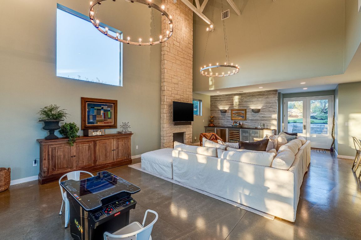 23601 Old Ferry Road, Unit 20 Spicewood, TX 78669 - Photo 10 of 40 a living room with fireplace furniture and a wooden floor