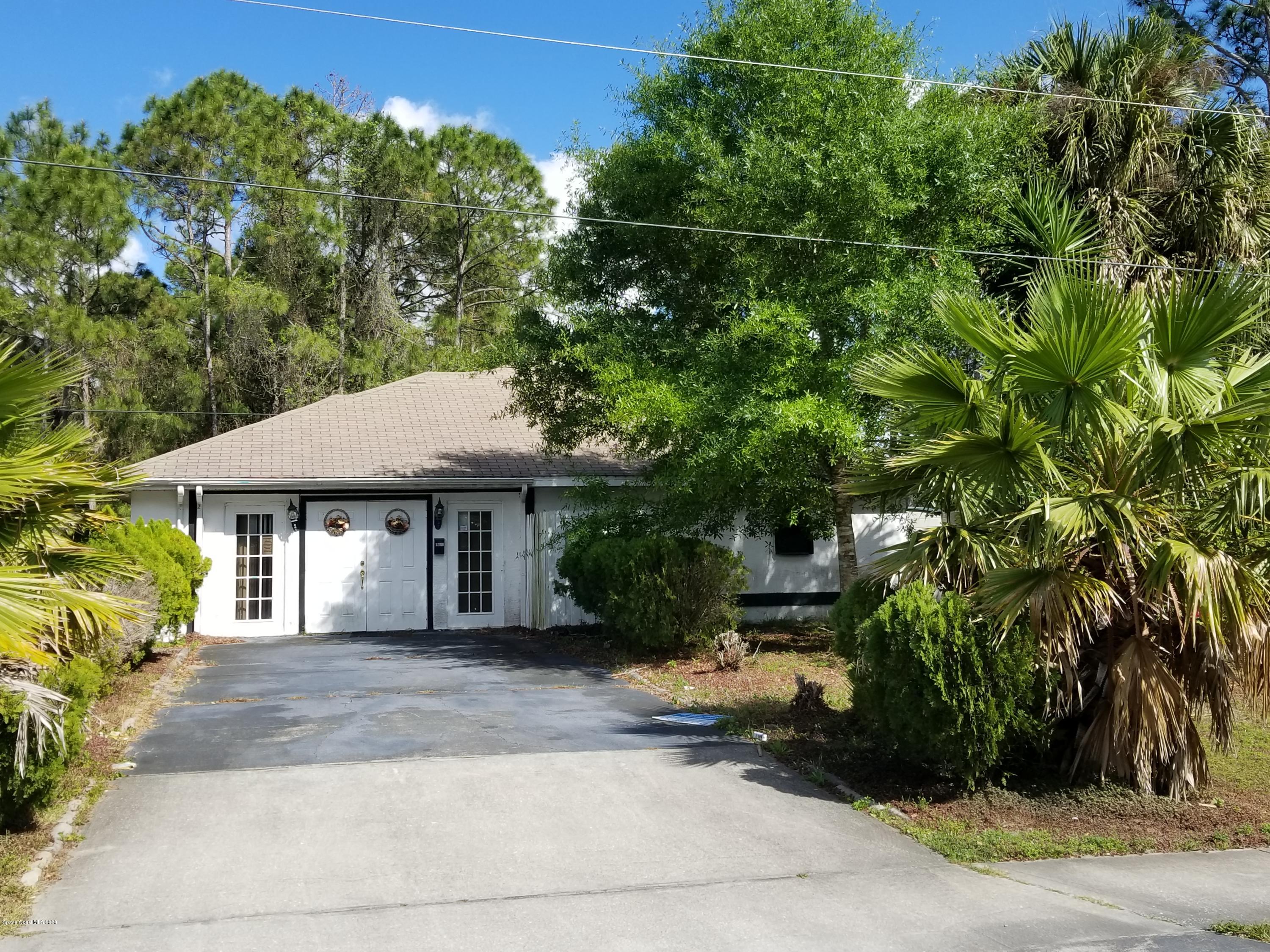 1298 Southwest Malabar Road Palm Bay, FL 32908 - Photo 9 of 9 a front view of a house with garden