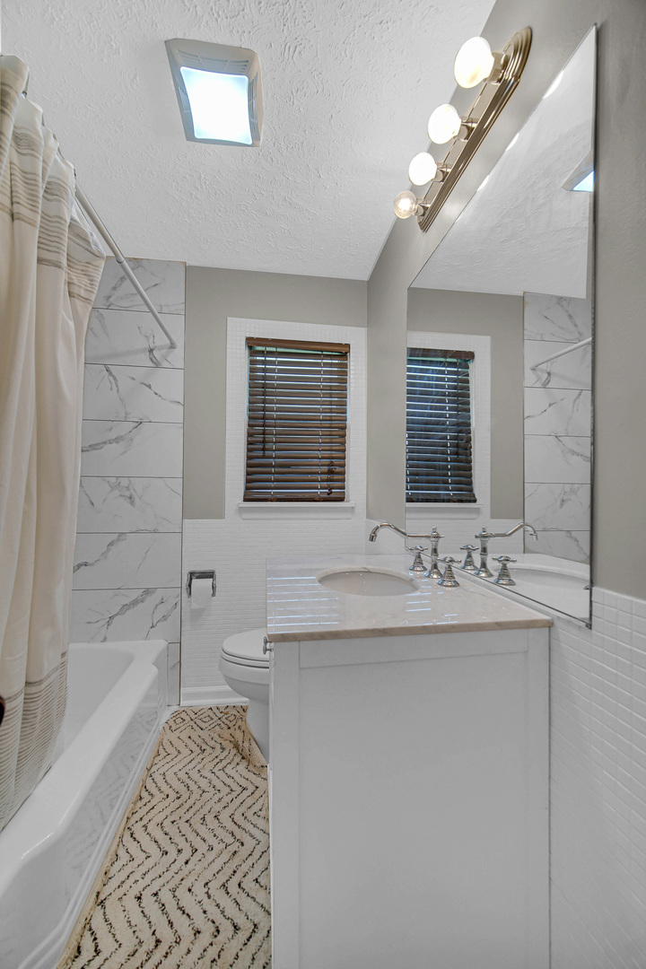 1107 Campbell Avenue Wheaton, IL 60189 - Photo 14 of 20 a bathroom with a sink a large mirror and a shower