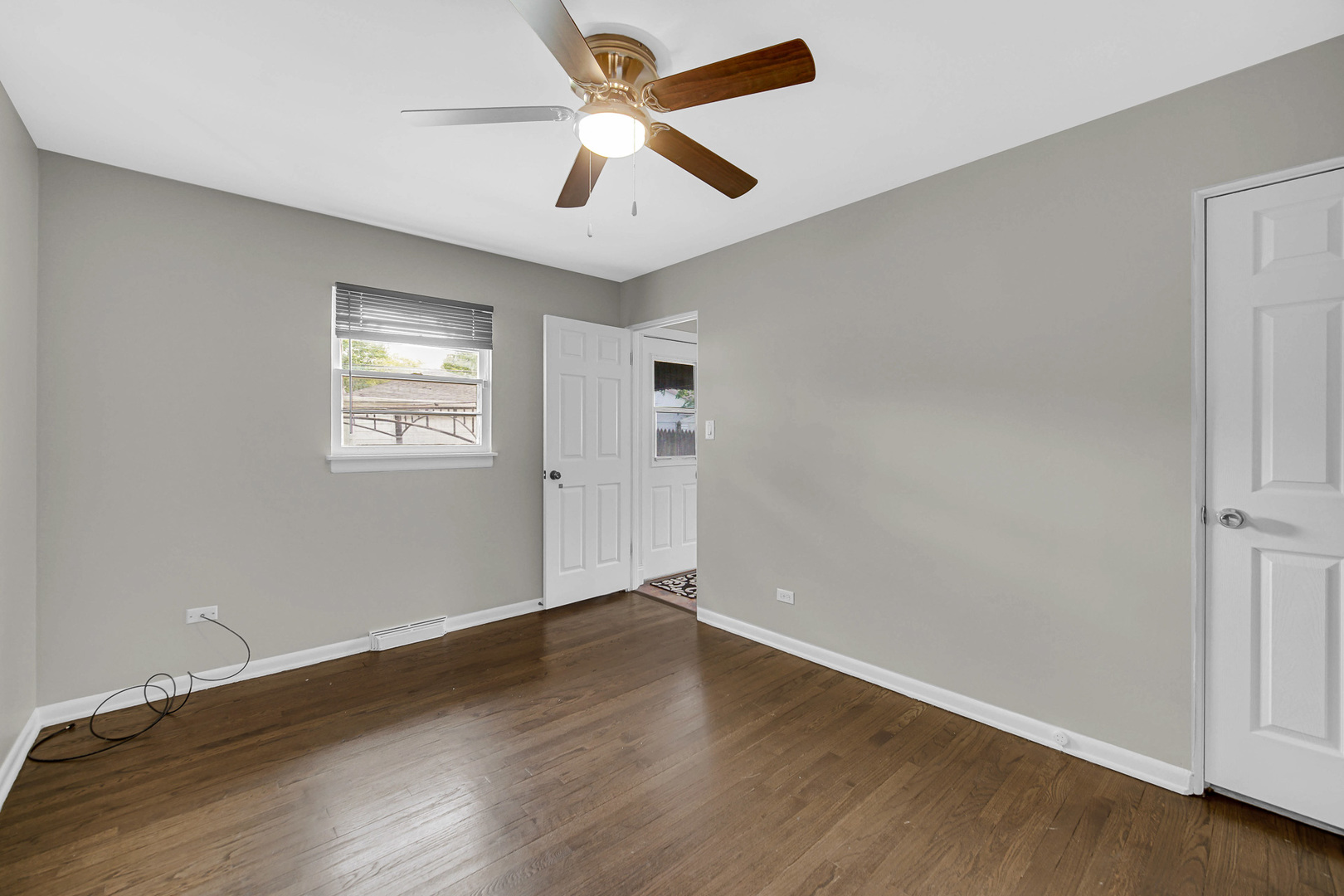 1107 Campbell Avenue Wheaton, IL 60189 - Photo 9 of 20 an empty room with wooden floor and windows