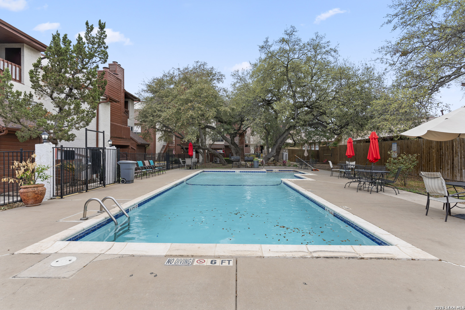 10527 Perrin Beitel Road, Unit C104 San Antonio, TX 78217 - Photo 11 of 11 a view of a tennis ground with large trees