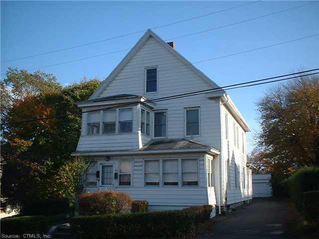 21 Lawlor Street Waterbury, CT 06708 - Photo 1 of 1 a front view of a house with a garden