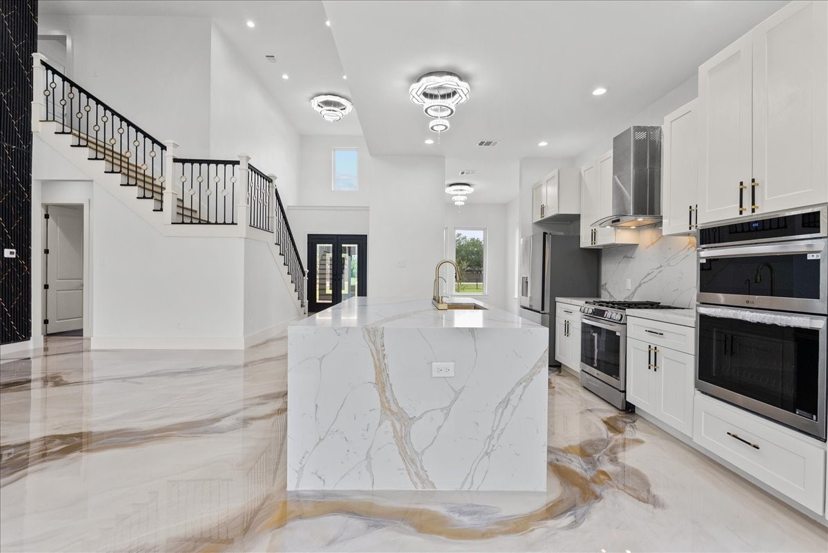 3237 Harkey Road Pearland, TX 77584 - Photo 12 of 46 Modern kitchen with sleek finishes, gas range, and double ovens.