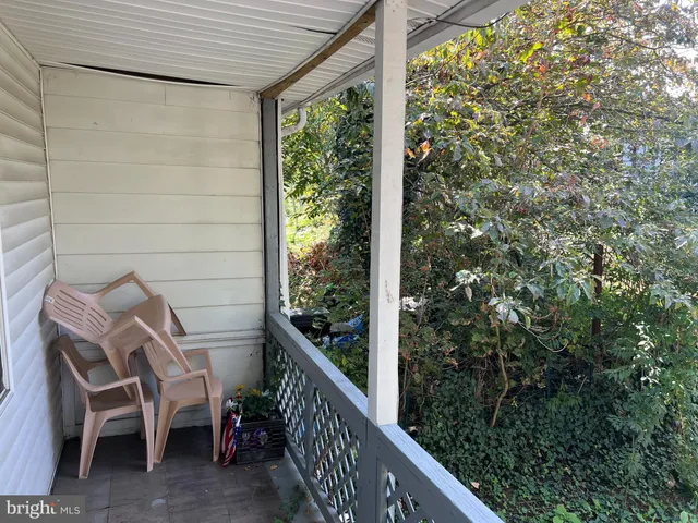 a view of a room with wooden floor and furniture