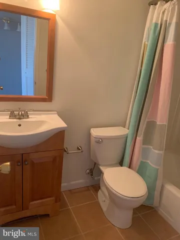 a white toilet sitting next to a bathroom sink
