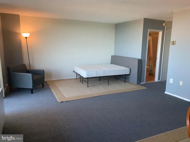 a living room with a couch and a lamp