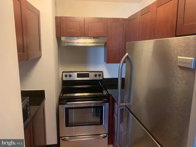 a kitchen with a stove and a refrigerator
