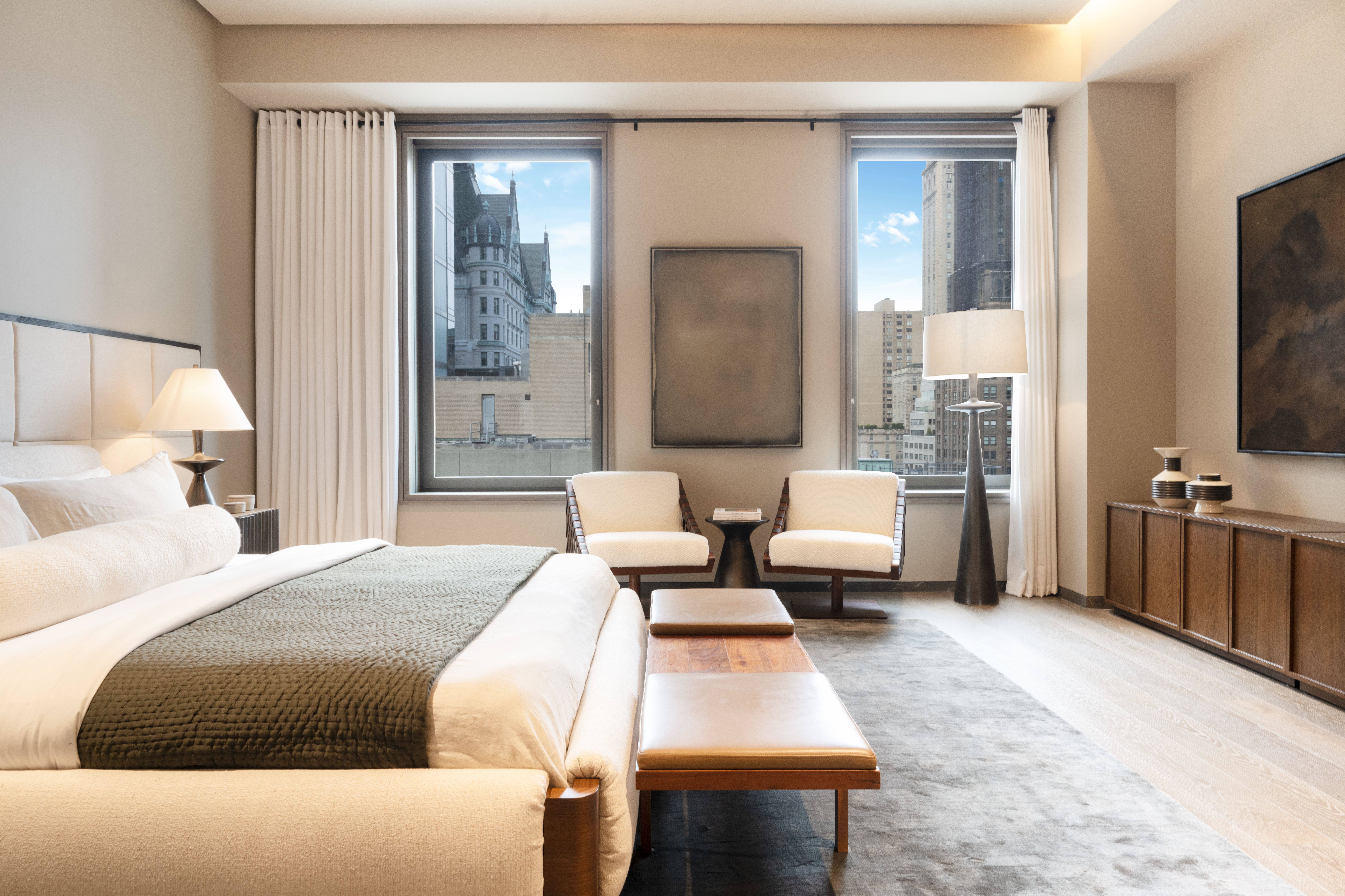 730 5th Avenue, Unit 16B Manhattan, NY 10019 - Photo 2 of 7 a bedroom with a bed and large mirror