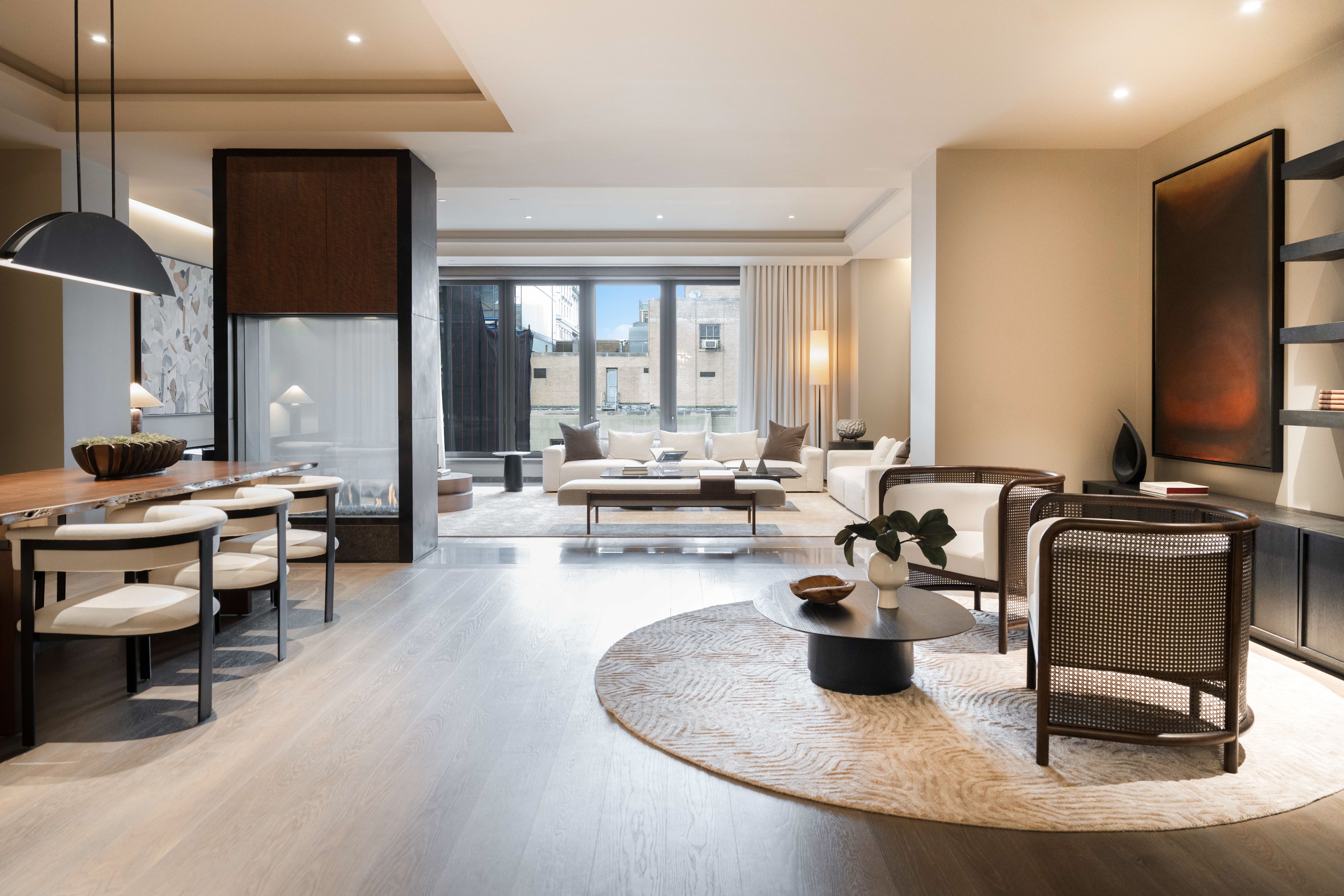 730 5th Avenue, Unit 16B Manhattan, NY 10019 - Photo 5 of 7 a living room with patio furniture and a large window