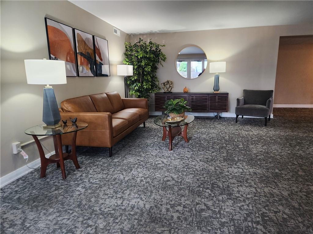 301 South Home Avenue, Unit 411 Pittsburgh, PA 15202 - Photo 3 of 20 a living room with furniture and a lamp