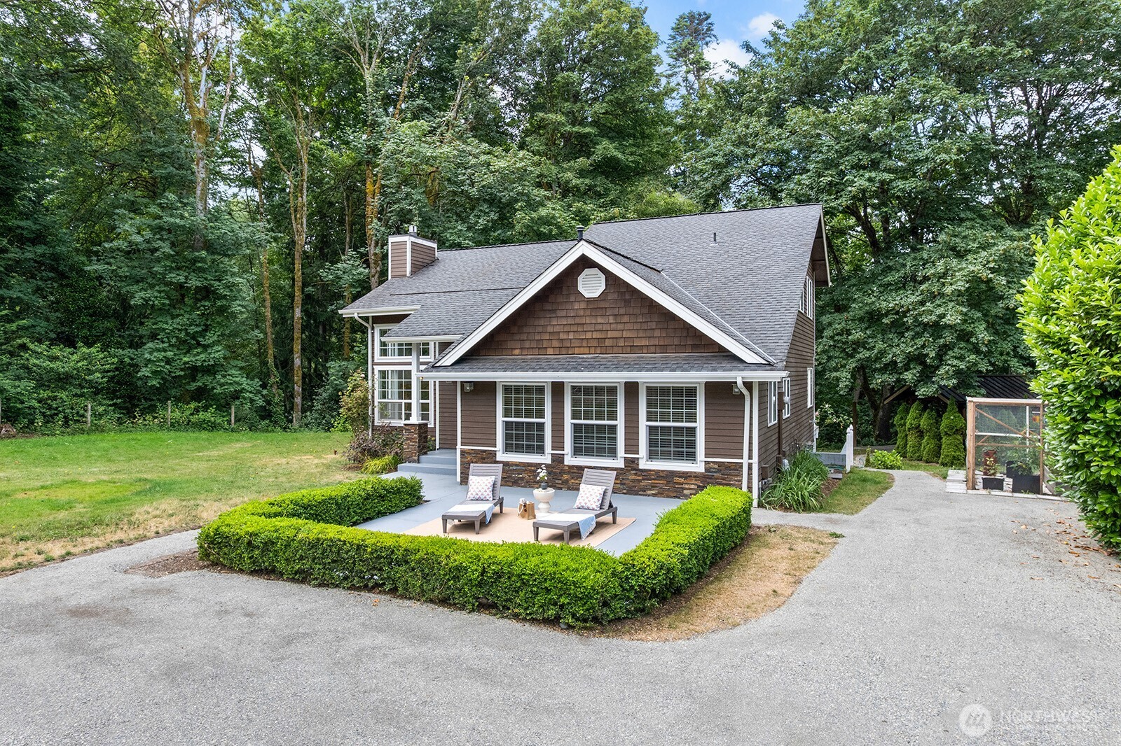 a front view of house with a garden and patio