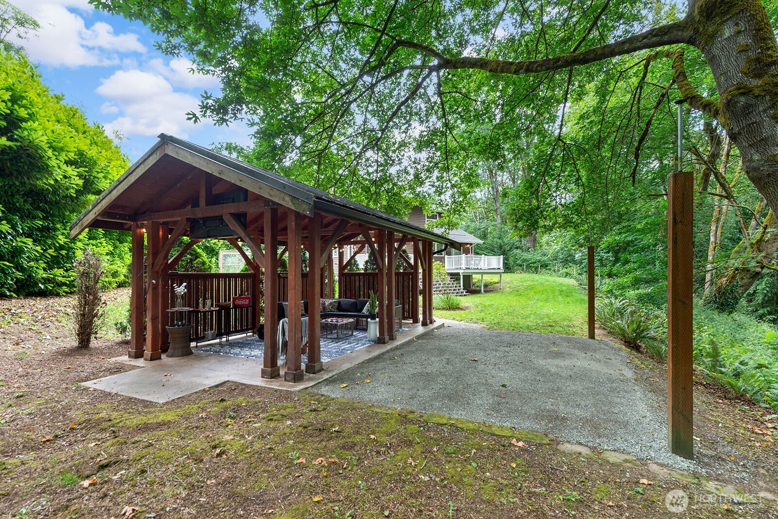 23835 Dockton Road Southwest Vashon, WA 98070 - Photo 23 of 38 a view of a patio with a table and chairs under an umbrella