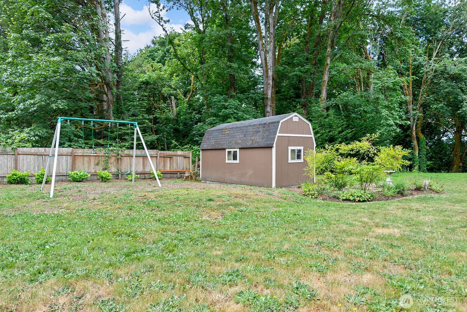 23835 Dockton Road Southwest Vashon, WA 98070 - Photo 26 of 38 a backyard of a house with plants and large trees