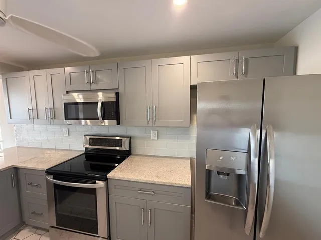 a kitchen with a refrigerator sink and microwave