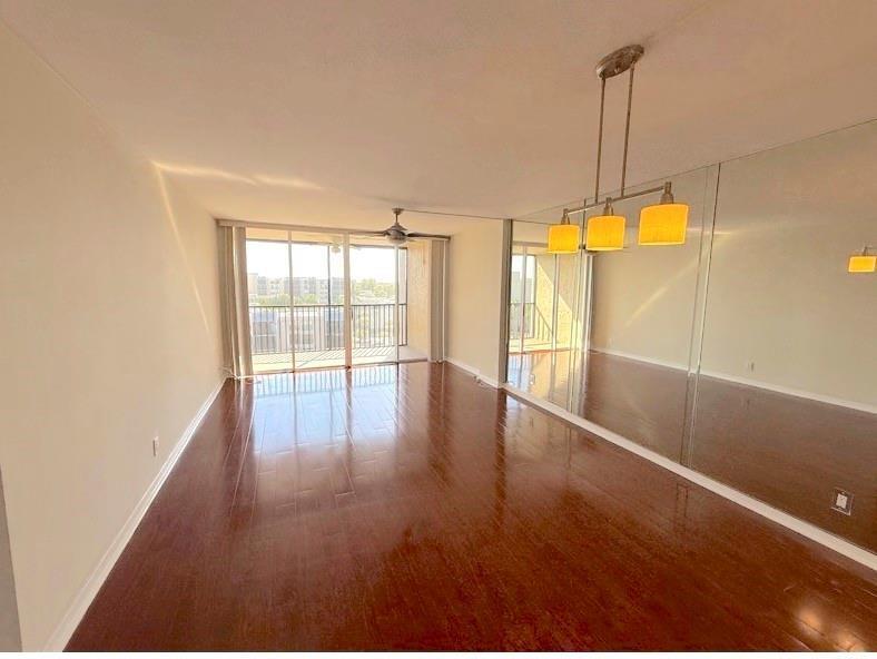9 Royal Palm Way Boca Raton, FL 33432 - Photo 4 of 10 a view of an empty room with wooden floor and a window