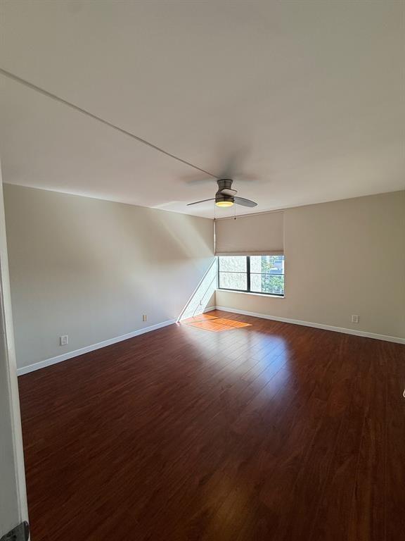 9 Royal Palm Way Boca Raton, FL 33432 - Photo 6 of 10 an empty room with wooden floor fan and windows