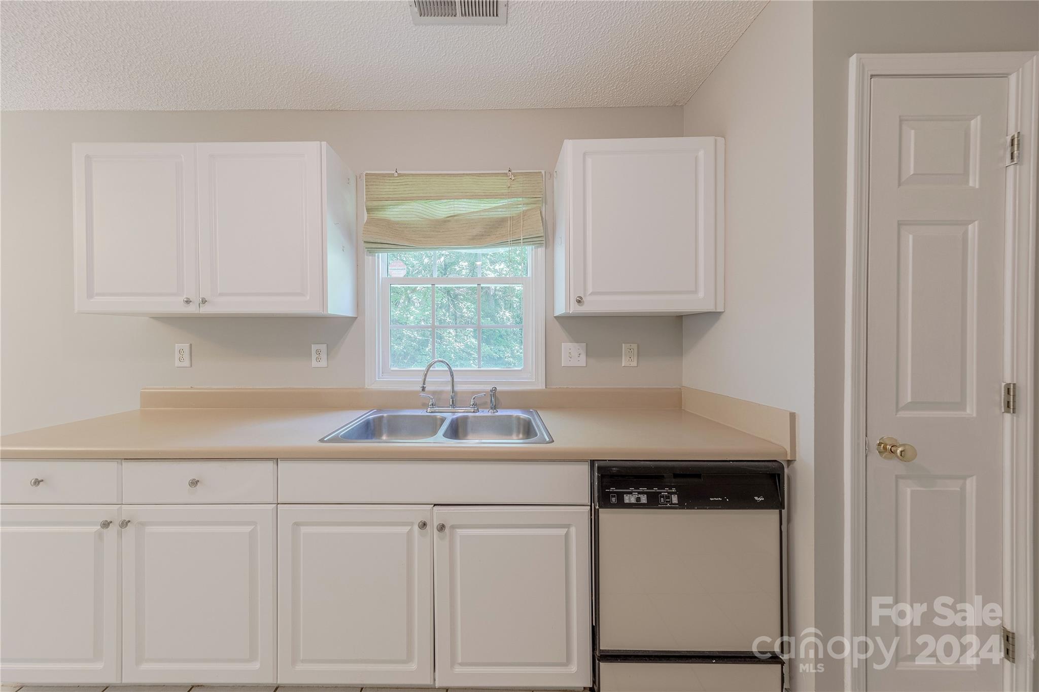 3230 McLendon Road Matthews, NC 28104 - Photo 13 of 29 a kitchen with granite countertop white cabinets and a sink