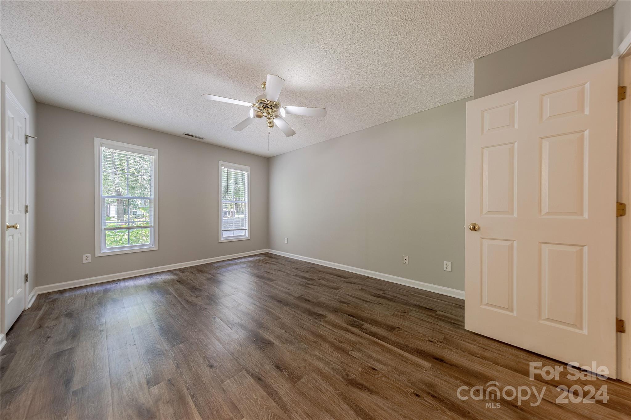 3230 McLendon Road Matthews, NC 28104 - Photo 15 of 29 a view of an empty room with a window and wooden floor