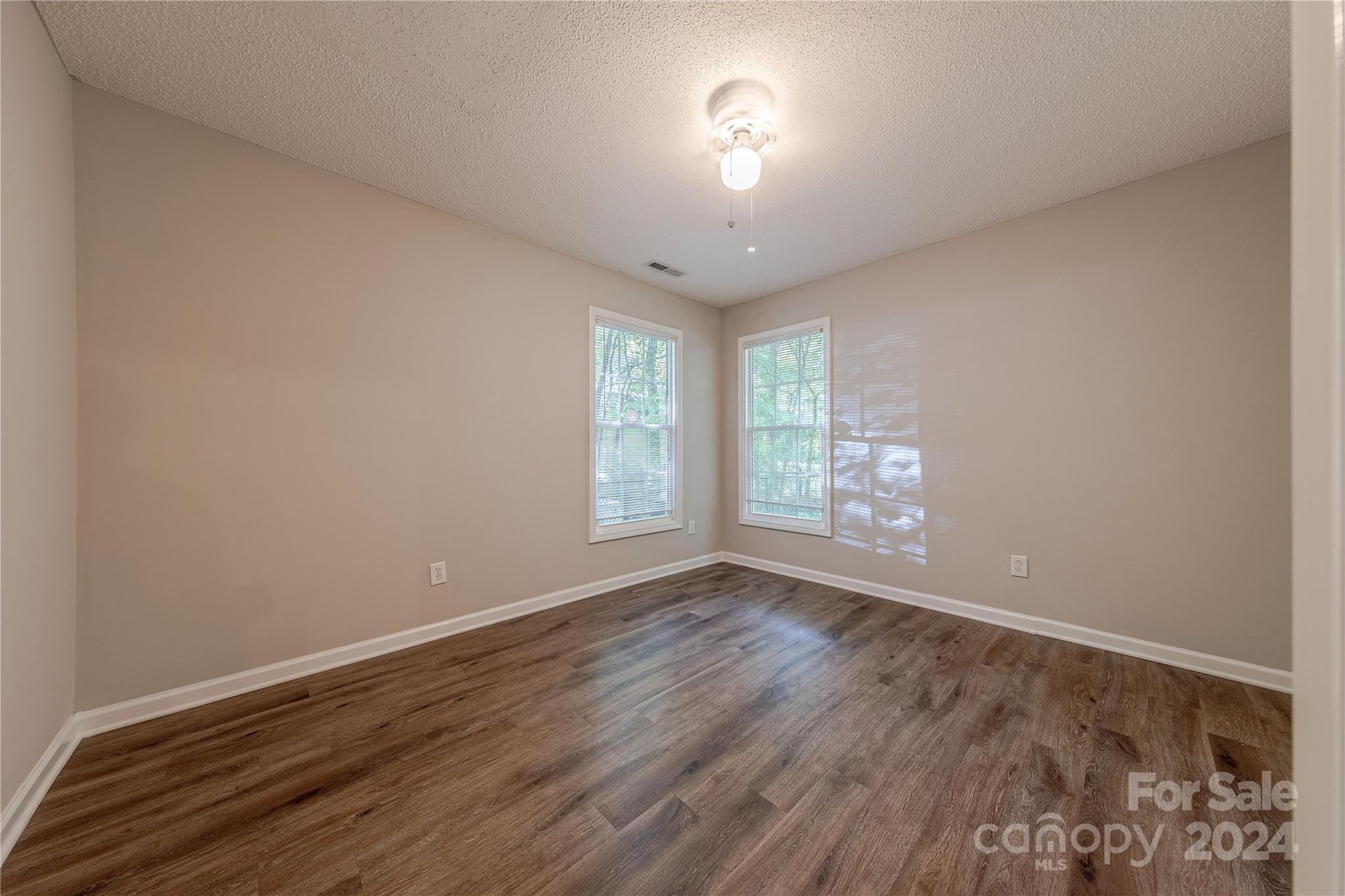 3230 McLendon Road Matthews, NC 28104 - Photo 19 of 29 wooden floor in an empty room with a window