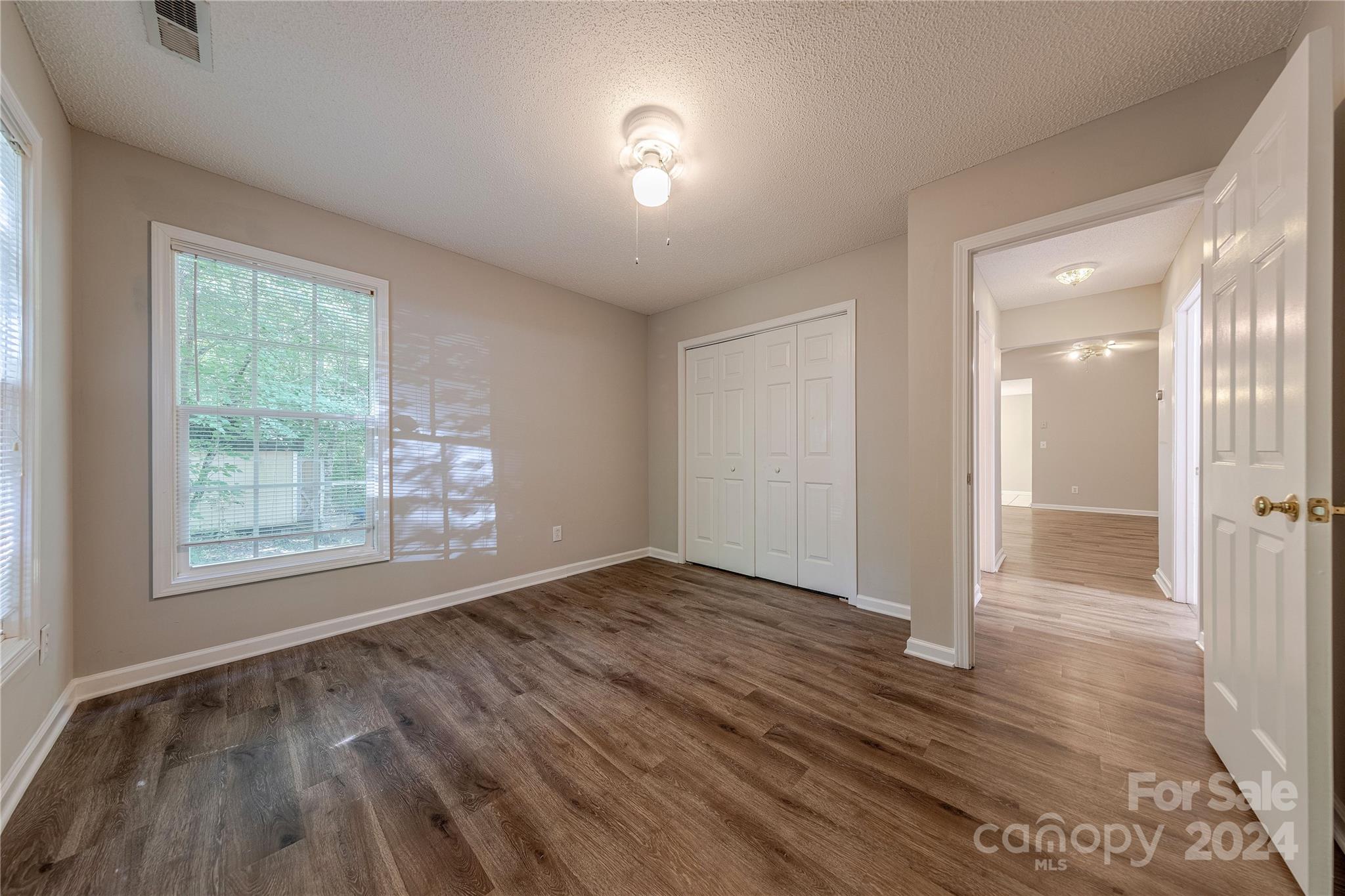 3230 McLendon Road Matthews, NC 28104 - Photo 22 of 29 an empty room with wooden floor and windows