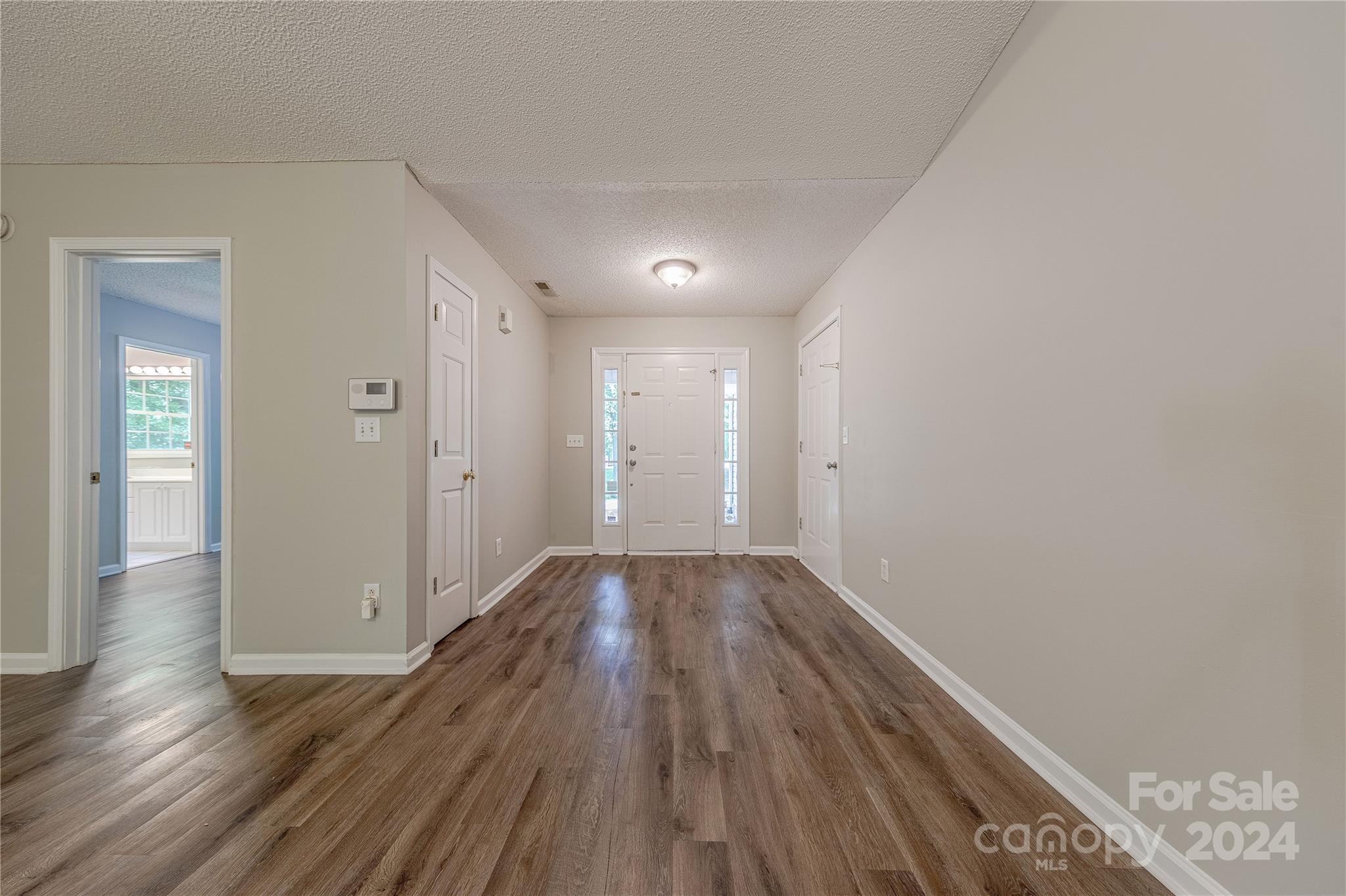 3230 McLendon Road Matthews, NC 28104 - Photo 4 of 29 a view of a hallway with wooden floor
