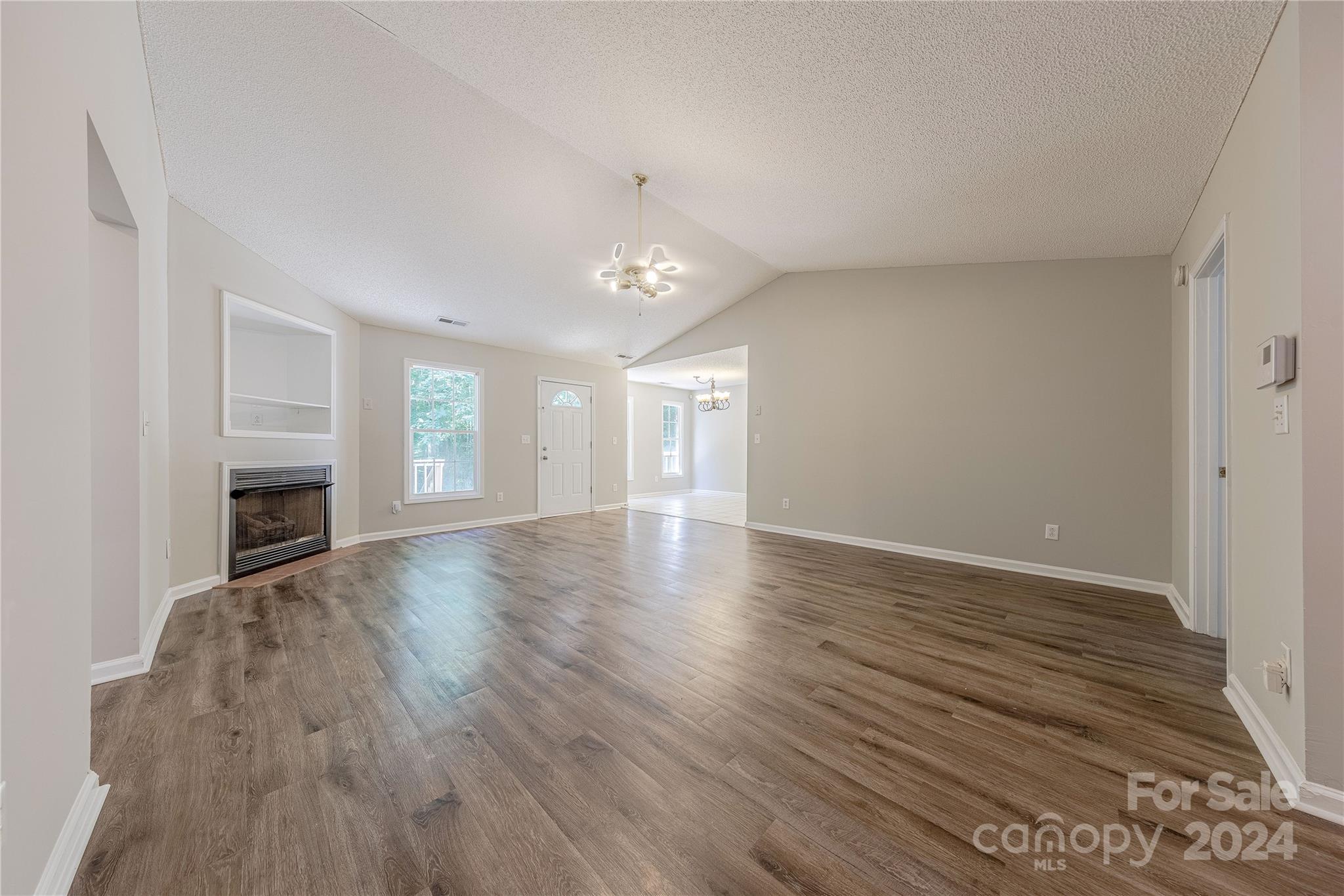 3230 McLendon Road Matthews, NC 28104 - Photo 5 of 29 a view of an empty room with wooden floor and a window