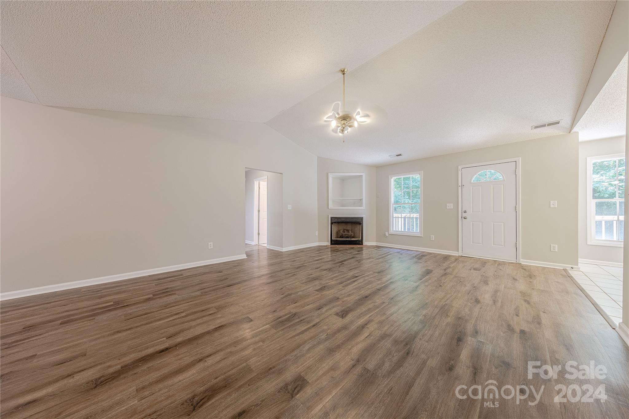 3230 McLendon Road Matthews, NC 28104 - Photo 6 of 29 a view of empty room with wooden floor and window