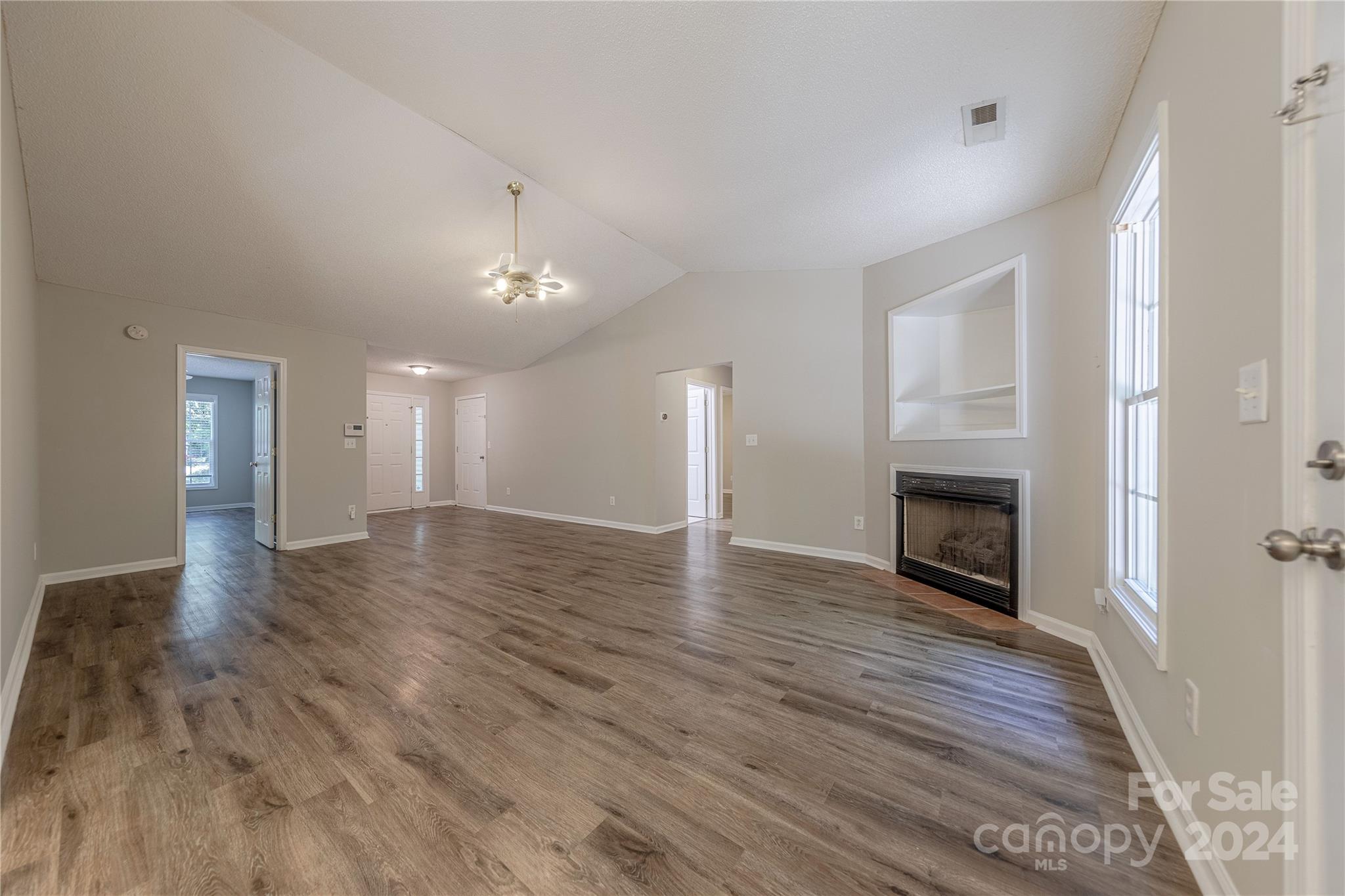 3230 McLendon Road Matthews, NC 28104 - Photo 7 of 29 wooden floor in an empty room with a fireplace