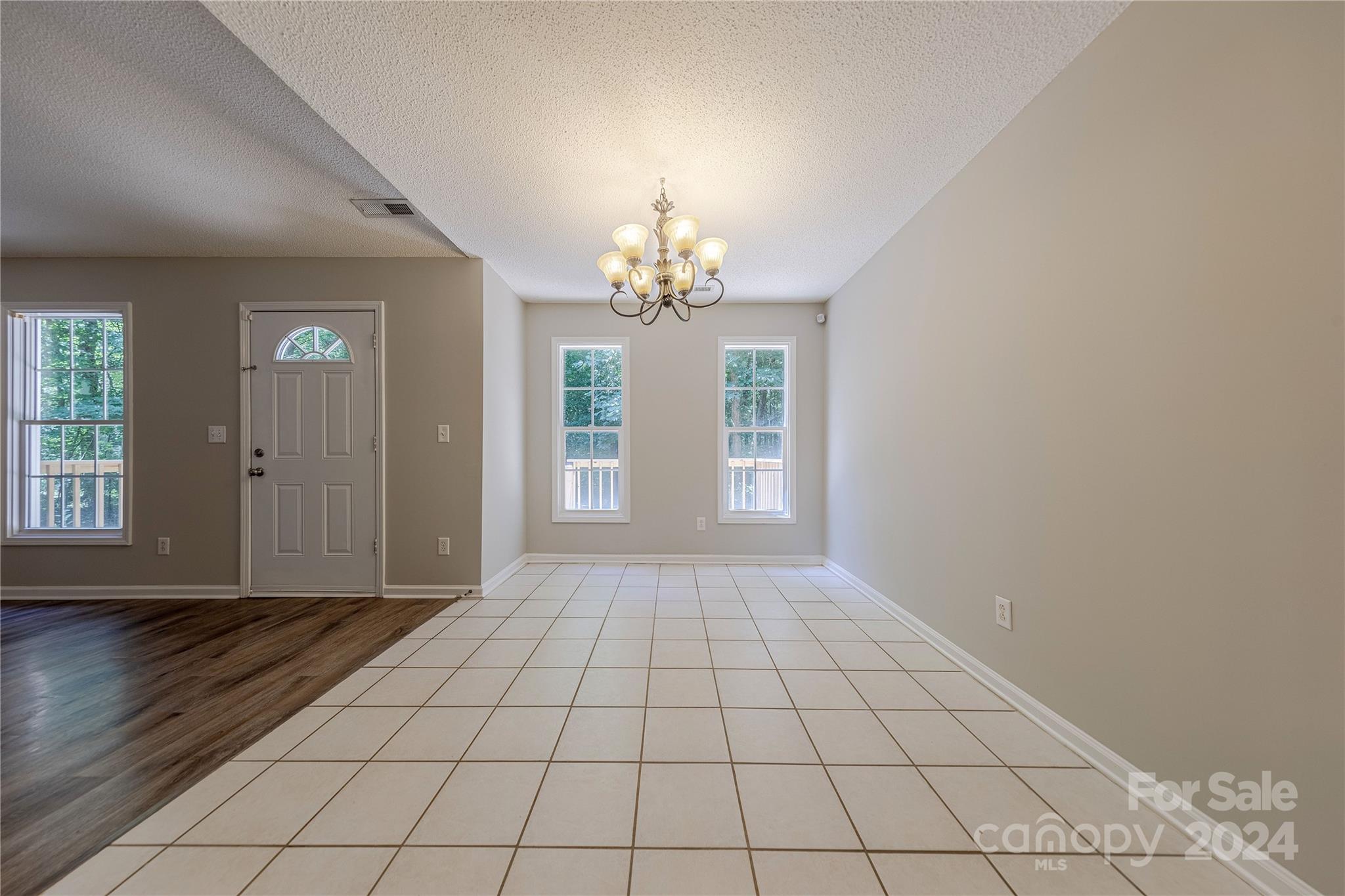 3230 McLendon Road Matthews, NC 28104 - Photo 9 of 29 a view of an empty room with window and chandelier fan