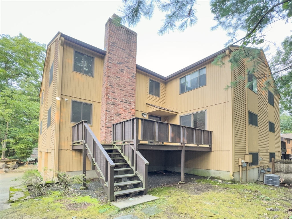 110 Mountain Gate Road, Unit 110 Ashland, MA 01721 - Photo 1 of 42 a view of a house with pool and chairs