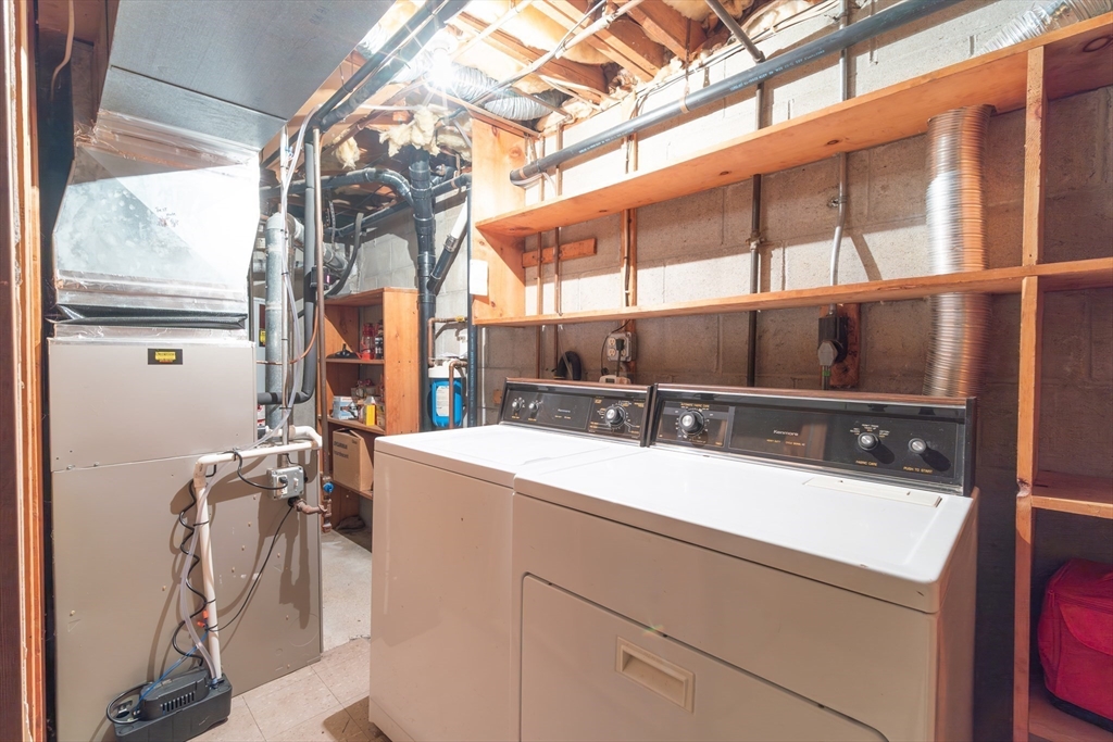 110 Mountain Gate Road, Unit 110 Ashland, MA 01721 - Photo 30 of 42 a room with a sink a washer and dryer